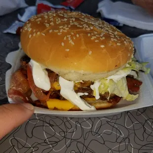 Double bacon cheeseburger with mayo grilled onions lettuce and tomato