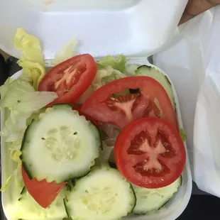 a salad in a styrofoam container