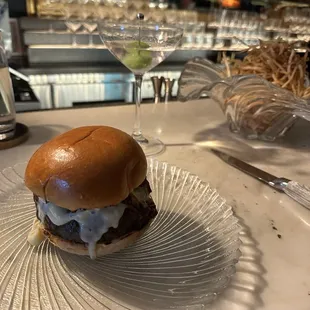 The Burger, comes with fries; Kasama cocktail in the back