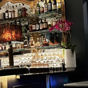 a bar with a lot of bottles and glasses