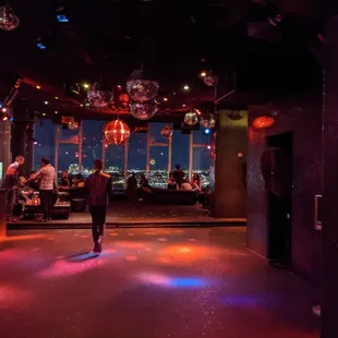 a man walking through a dimly lit bar