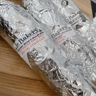 a sandwich wrapped in aluminum foil