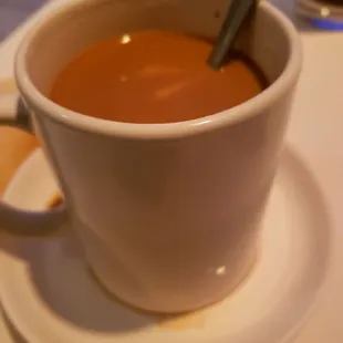 a cup of coffee on a saucer