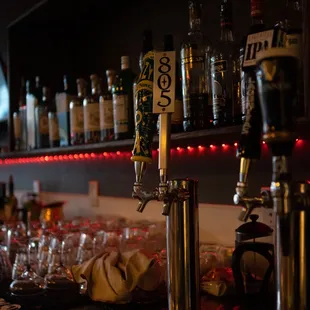 a bar with a lot of bottles and glasses