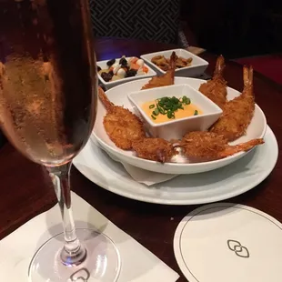 Crispy coconut shrimp and a glass of champagne.