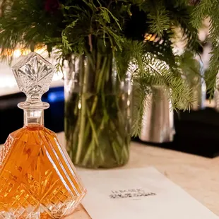 a vase of flowers and a perfume bottle