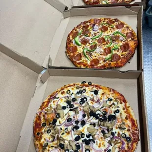 three pizzas in a pizza box
