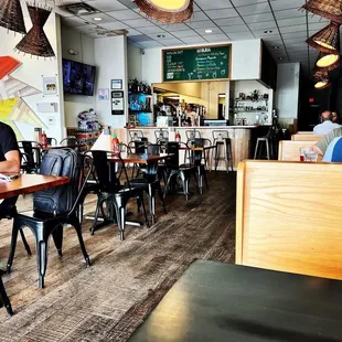 people sitting at tables in a restaurant