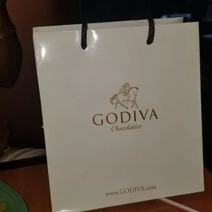 a white shopping bag sitting on a table