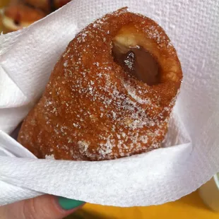 a hand holding a pastry