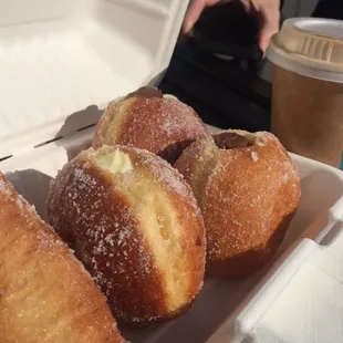 Bombolinis, cannoli, and blue bottle. Heavenly farmer&apos;s market breakfast for a sweet tooth