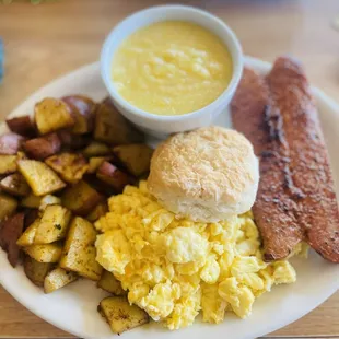 country breakfast  eggs scrambled with cheese so light and fluffy !!! sausage not too spicy and grits hot and full of butter !!! l