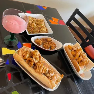 Catfish po boy, shrimp po boy, dirty rice, fried gator, and a delicious watermelon boozy slushee!