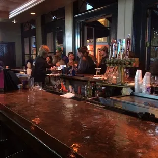 a group of people sitting at a bar
