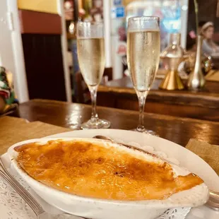 a plate of food and two glasses of champagne