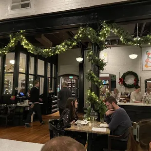 people sitting at tables in a restaurant