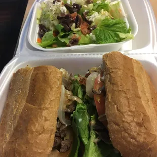 Steak sandwich and side Greek salad