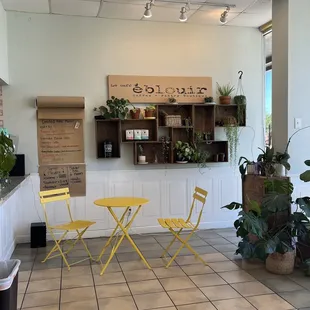 a yellow table and chairs
