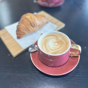 a cup of coffee and a croissant