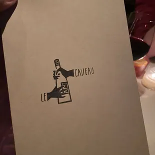 a person holding up a menu