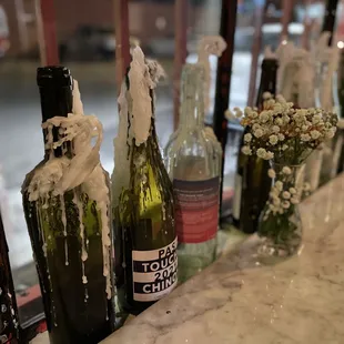 a row of empty wine bottles on a counter