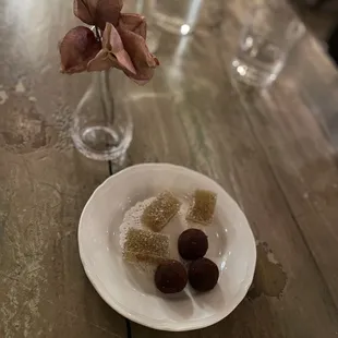 a plate of candies on a wooden table