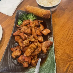 Bourbon chicken with white rice and pork egg rolls