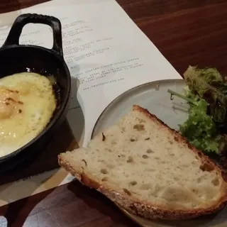 Schainer Farms Sunny Side up Egg, Baby Greens, Brown Butter, Lemon, Parsley, Reggiano Toast