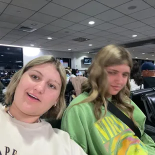 two women sitting in an airport