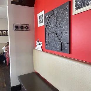 a red wall with a map on it