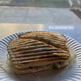 Sourdough bread with turkey, lettuce, pickles, pepperoncini, mozzarella, and bell peppers.
