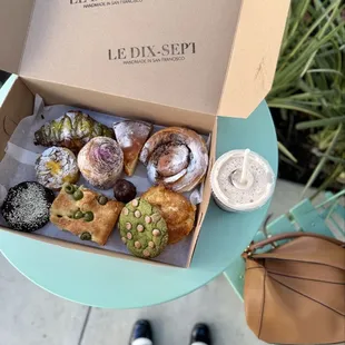 Box of pastries and rose latte with pistachio milk
