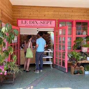two people standing in front of the entrance