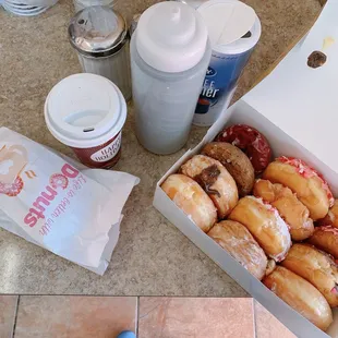 a box of doughnuts and a cup of coffee