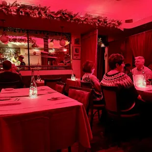 people sitting at tables in a restaurant