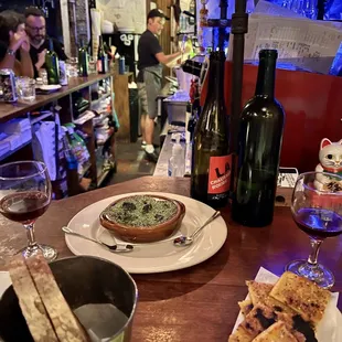 two plates of food and a glass of wine