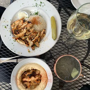 two plates of food and a glass of wine