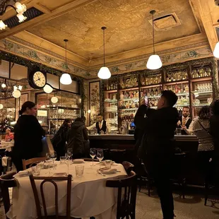 people sitting at tables in a restaurant