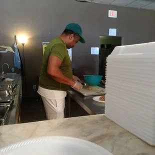 The owner preps a plate.
