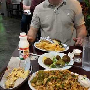 What a spread omg chicken shawarma plate with lentil soup spiced rice and gyro wrap with fries
