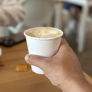 a person holding a cup of coffee