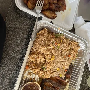 a tray of rice, meat, and vegetables