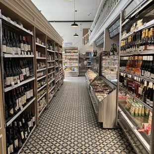 a grocery store aisle with wine on the shelves
