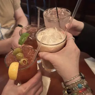 a group of people toasting with drinks