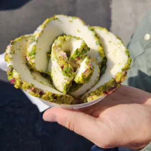 a person holding a piece of cake