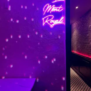 a purple neon sign in a dimly lit room