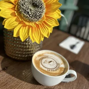 a cup of coffee and a sunflower