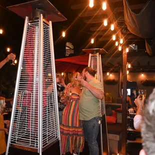 a man and woman standing in front of a heater