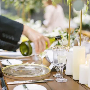 Servers pouring wine