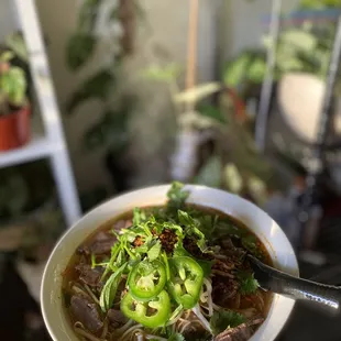 a person holding a bowl of soup